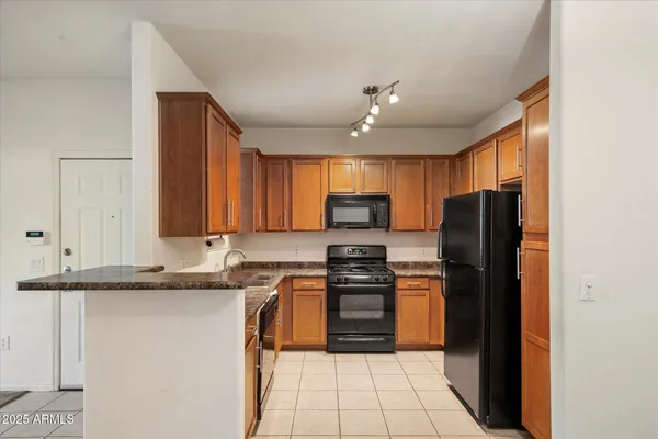 a kitchen with stainless steel appliances granite countertop a refrigerator stove microwave and sink