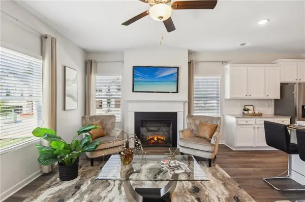 a living room with furniture fireplace and a window