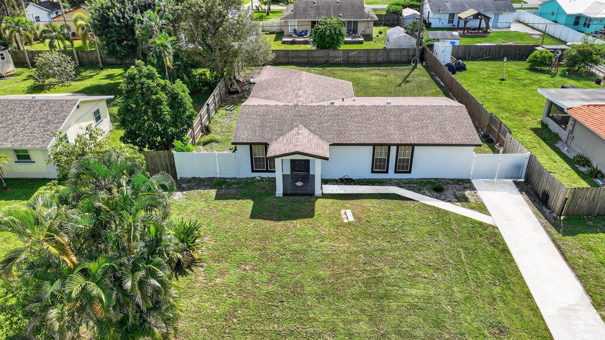 5196 Palm Ridge Boulevard Delray Beach, FL 33484 - Photo 1 of 24 an aerial view of a house with swimming pool and garden