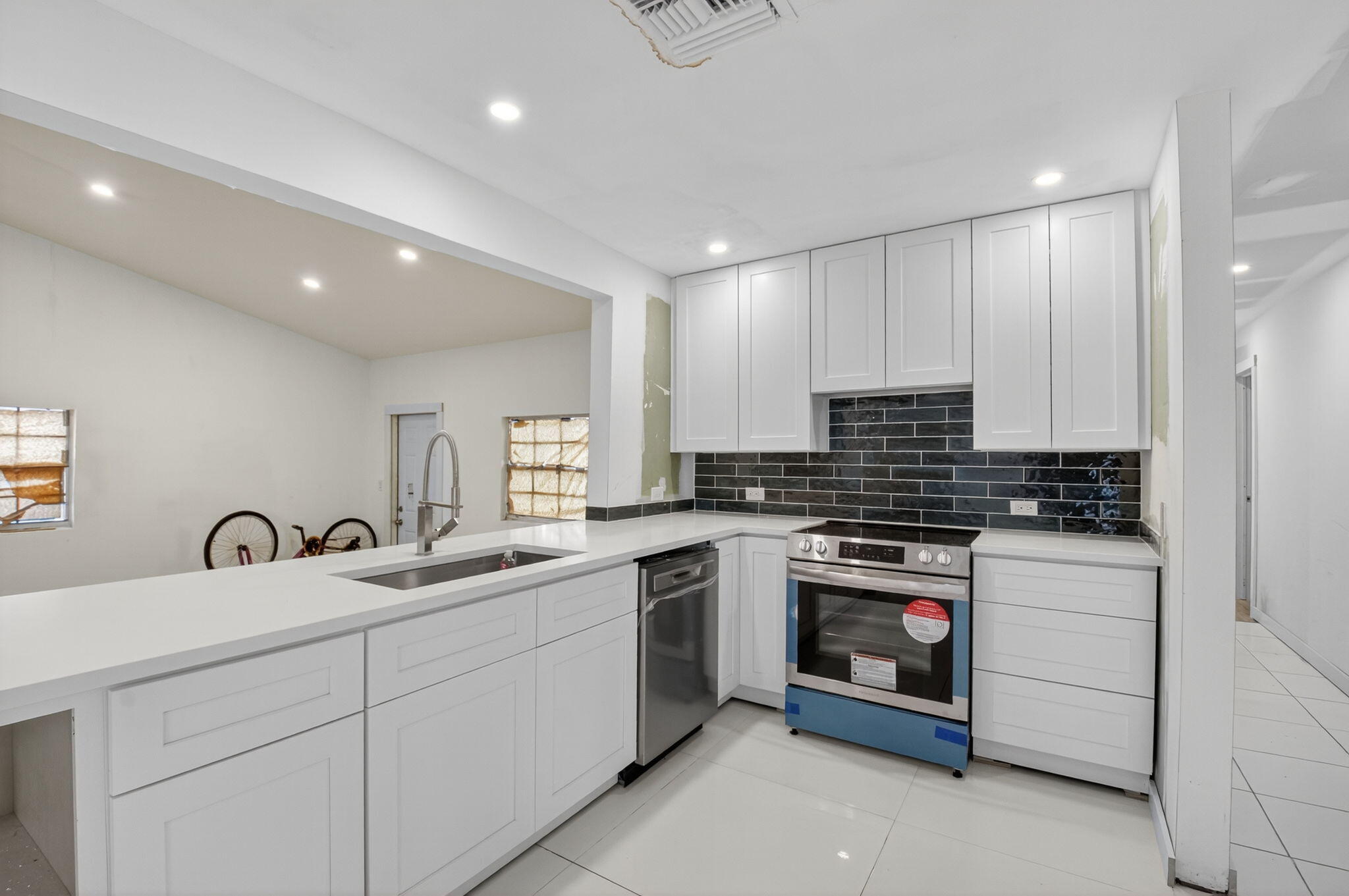 5196 Palm Ridge Boulevard Delray Beach, FL 33484 - Photo 2 of 24 a kitchen with a sink stove and cabinets