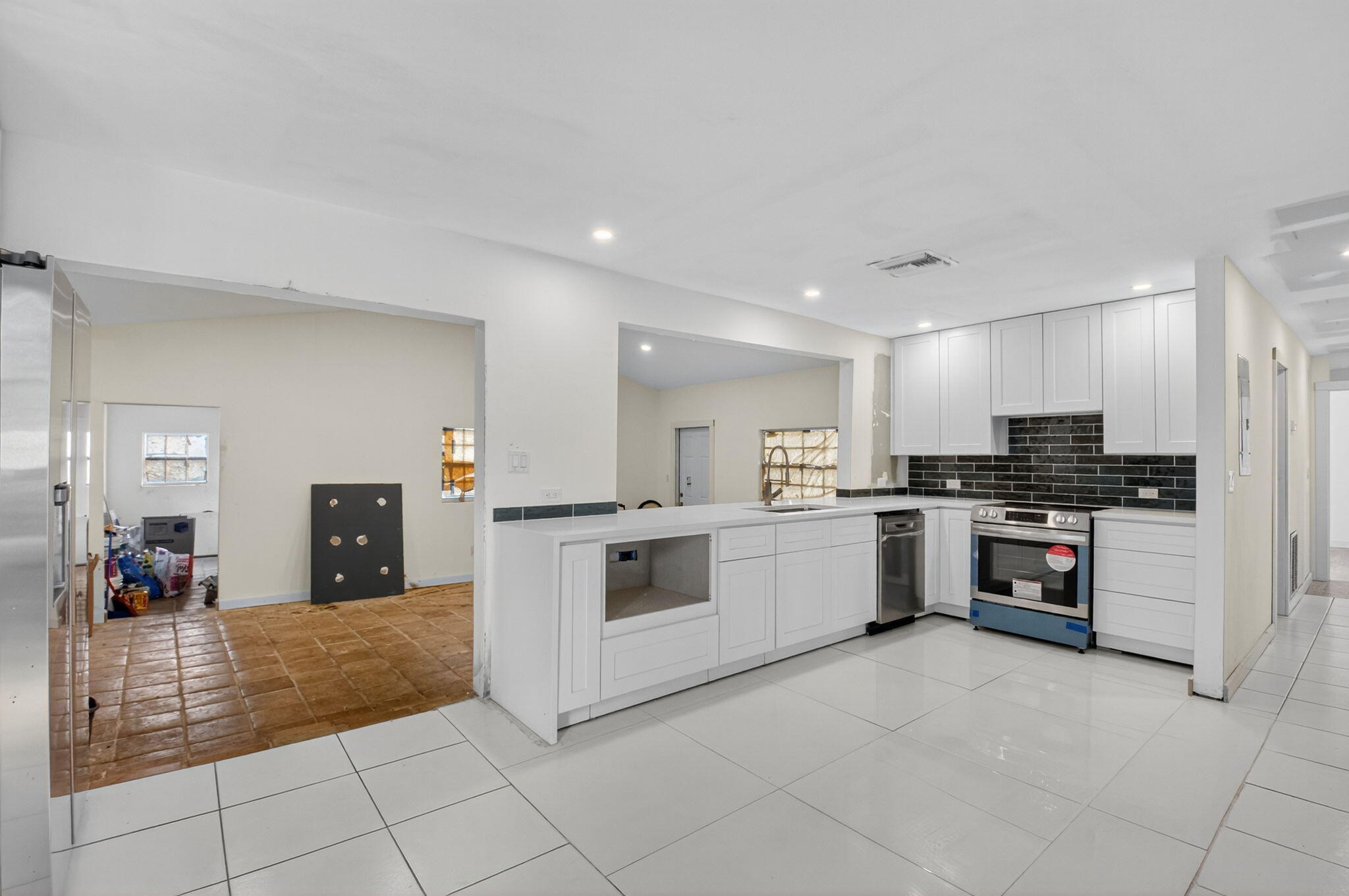 5196 Palm Ridge Boulevard Delray Beach, FL 33484 - Photo 6 of 24 a large kitchen with cabinets and stainless steel appliances