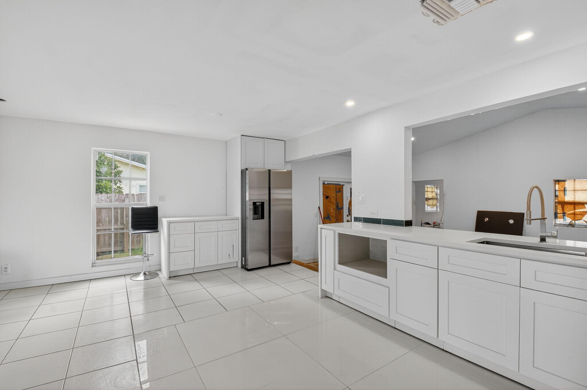 5196 Palm Ridge Boulevard Delray Beach, FL 33484 - Photo 8 of 24 a kitchen with granite countertop a refrigerator and a stove top oven