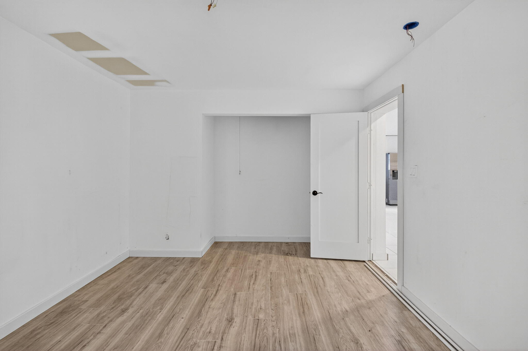 5196 Palm Ridge Boulevard Delray Beach, FL 33484 - Photo 10 of 24 a view of a room with wooden floor and white walls