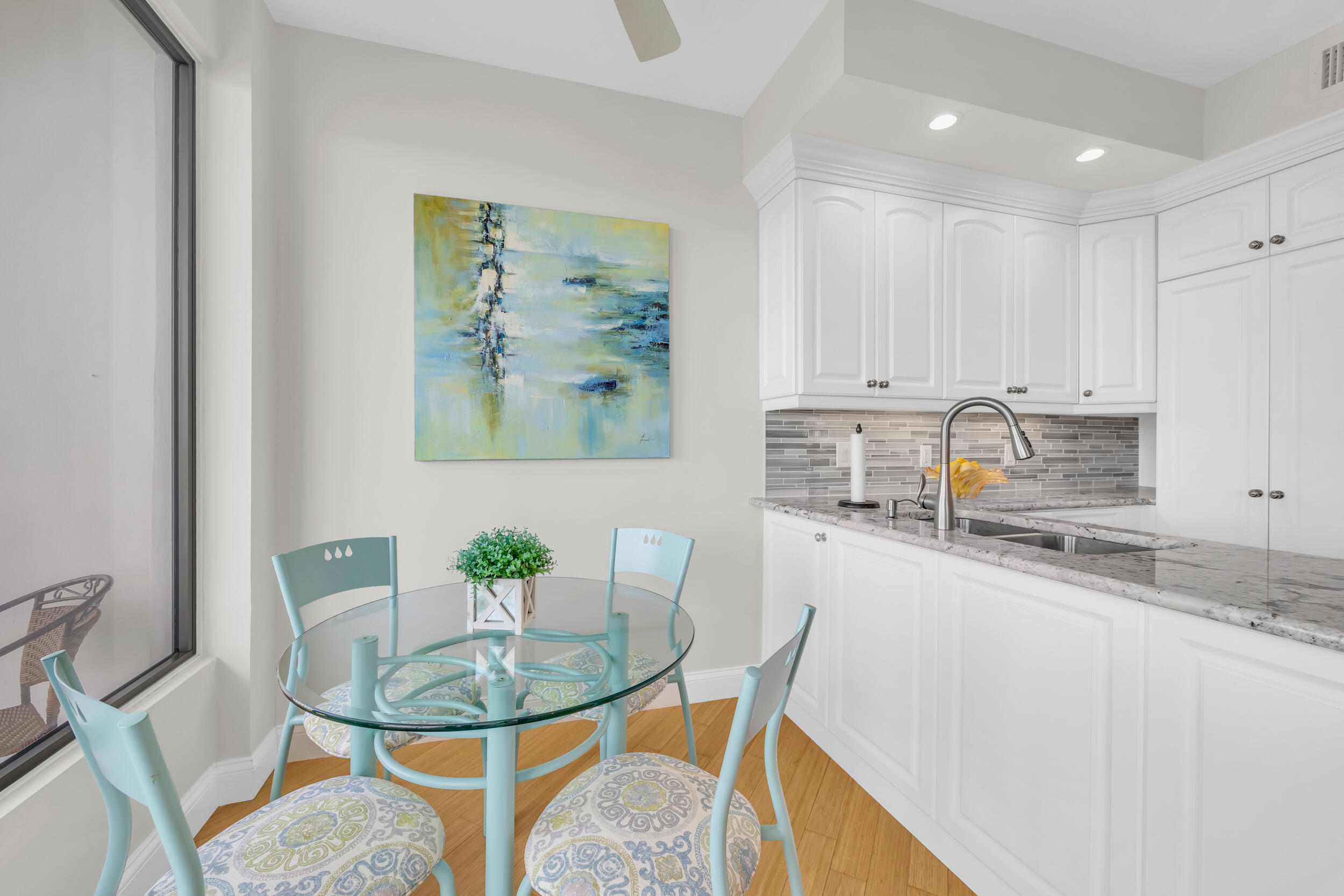 200 Waterway Road, Unit 206 Tequesta, FL 33469 - Photo 13 of 49 a kitchen with stainless steel appliances granite countertop a sink a stove a dining table and chairs