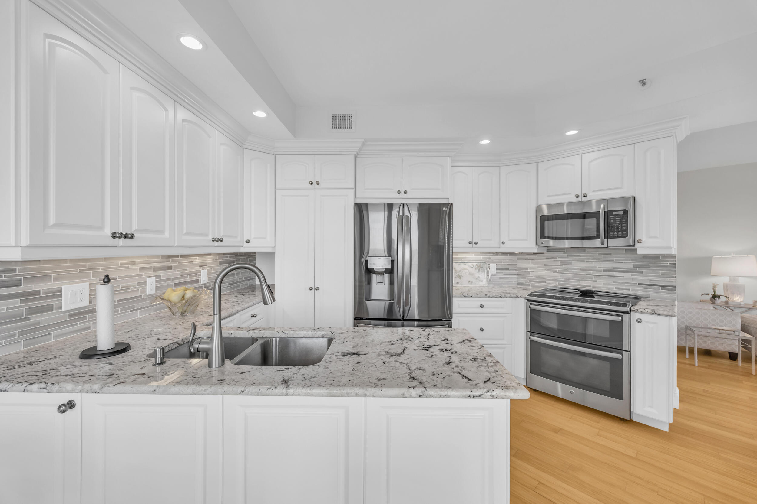 200 Waterway Road, Unit 206 Tequesta, FL 33469 - Photo 15 of 49 a kitchen with stainless steel appliances granite countertop a sink stove and refrigerator