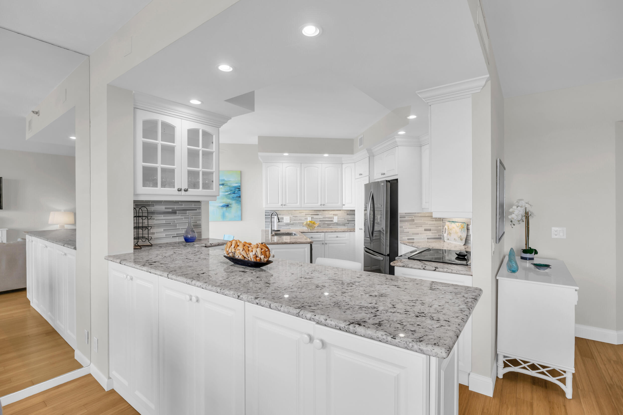 200 Waterway Road, Unit 206 Tequesta, FL 33469 - Photo 17 of 49 a kitchen with granite countertop a sink and a stove top oven