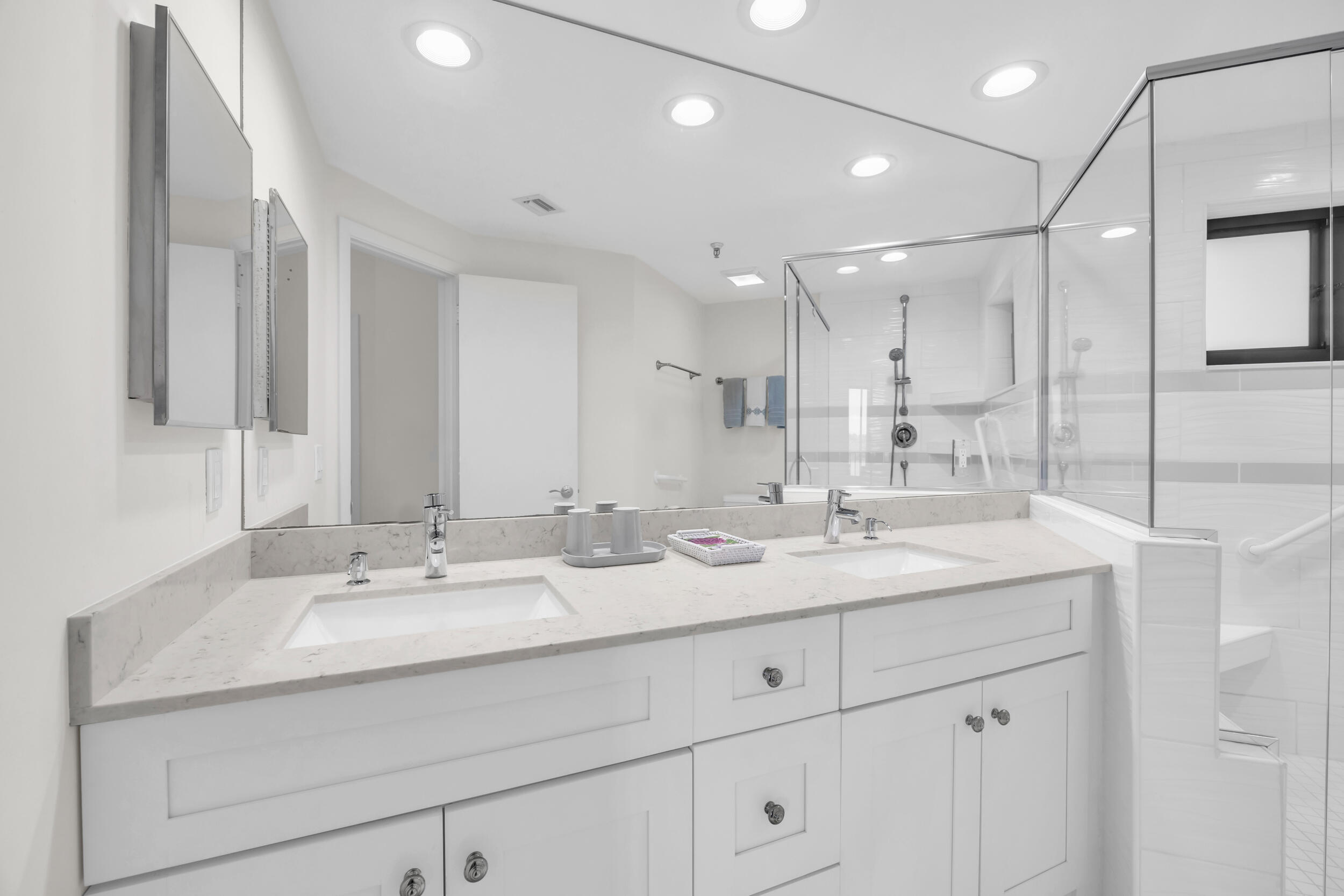 200 Waterway Road, Unit 206 Tequesta, FL 33469 - Photo 27 of 49 a bathroom with double sink and a mirror