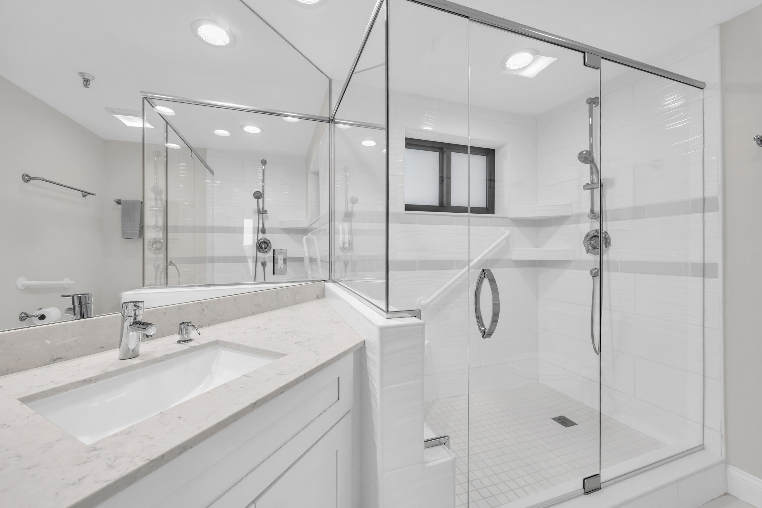 200 Waterway Road, Unit 206 Tequesta, FL 33469 - Photo 28 of 49 a bathroom with a shower sink and mirror