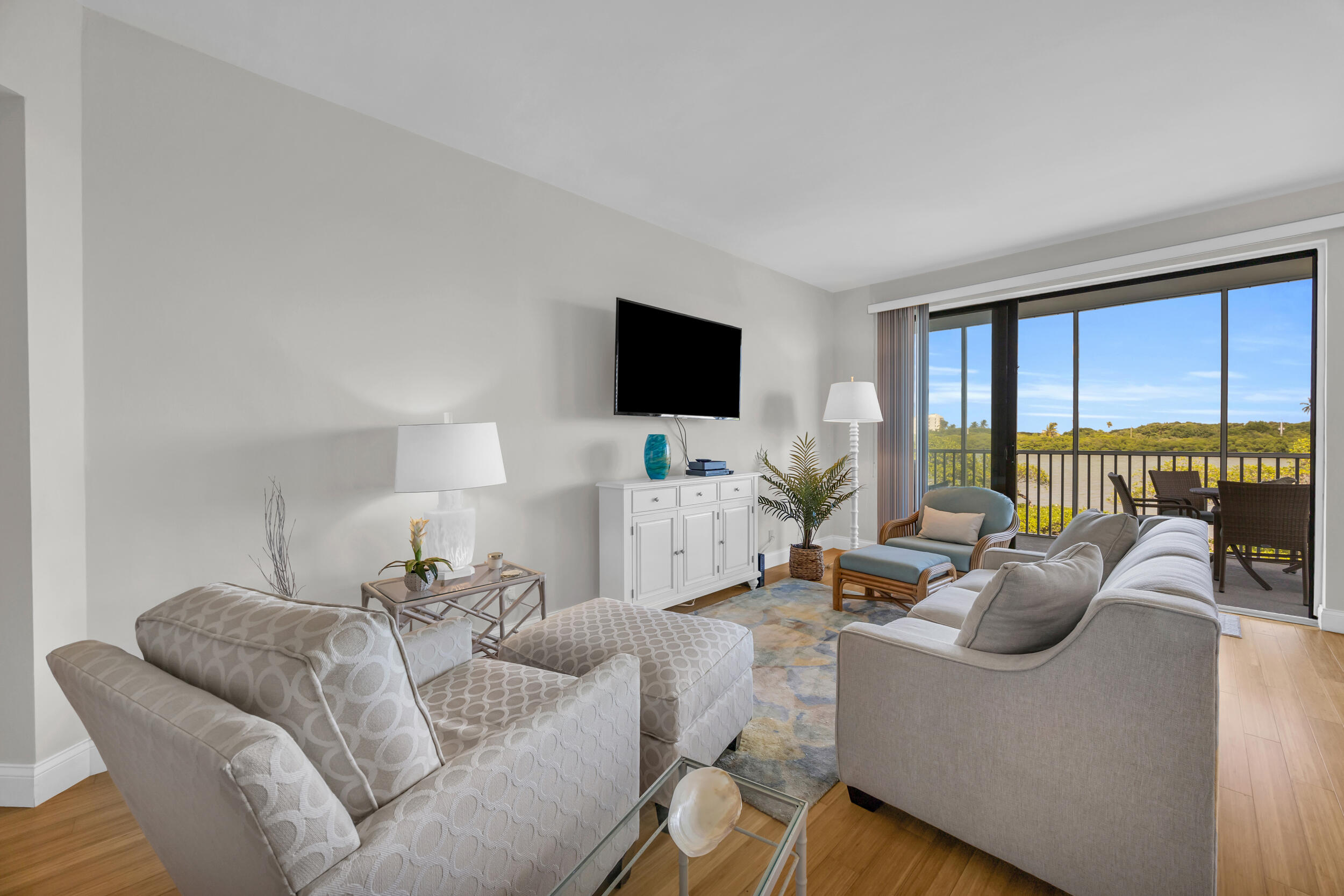 200 Waterway Road, Unit 206 Tequesta, FL 33469 - Photo 4 of 49 a living room with furniture and a flat screen tv
