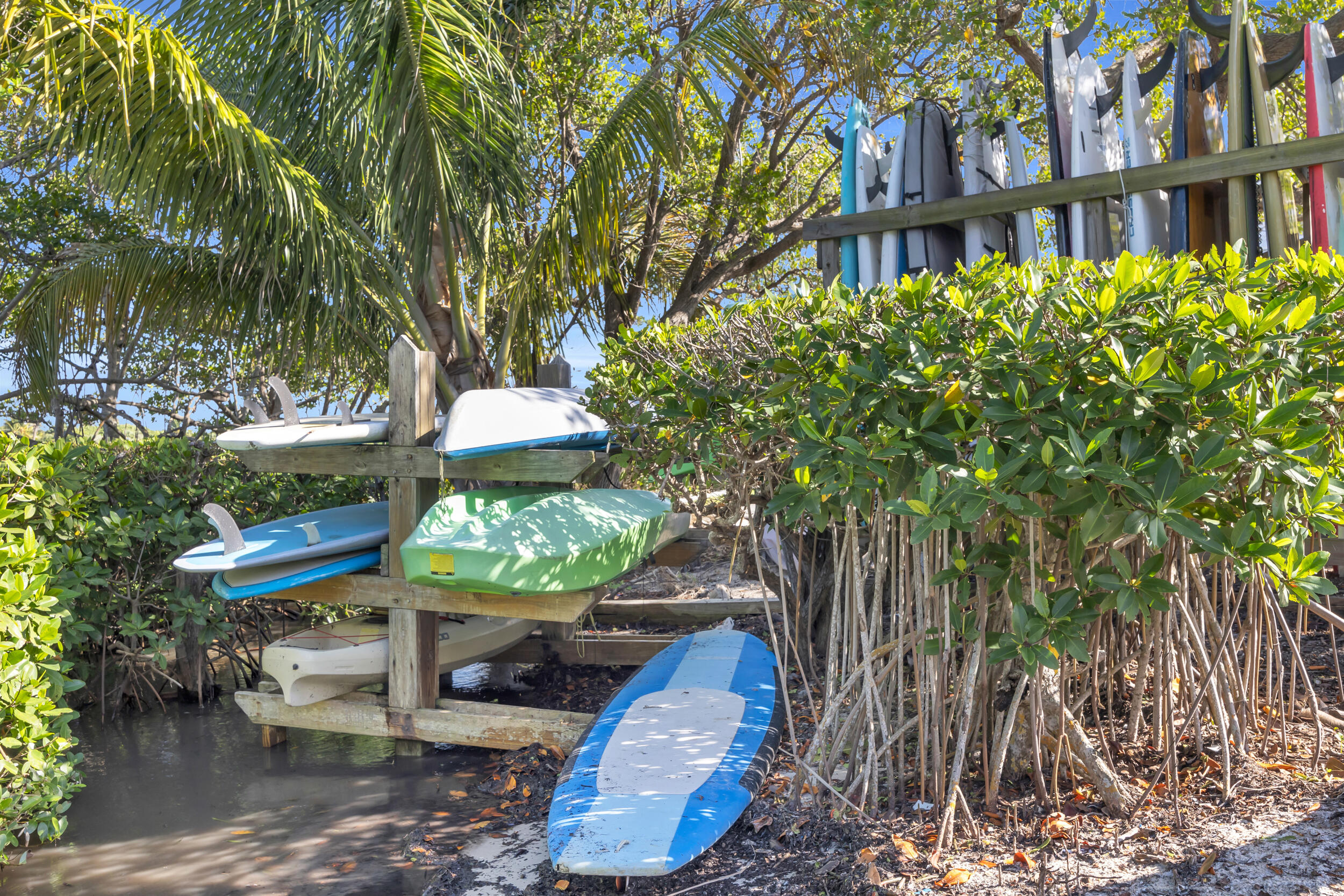 200 Waterway Road, Unit 206 Tequesta, FL 33469 - Photo 42 of 49 a view of a brick house with a yard and large trees