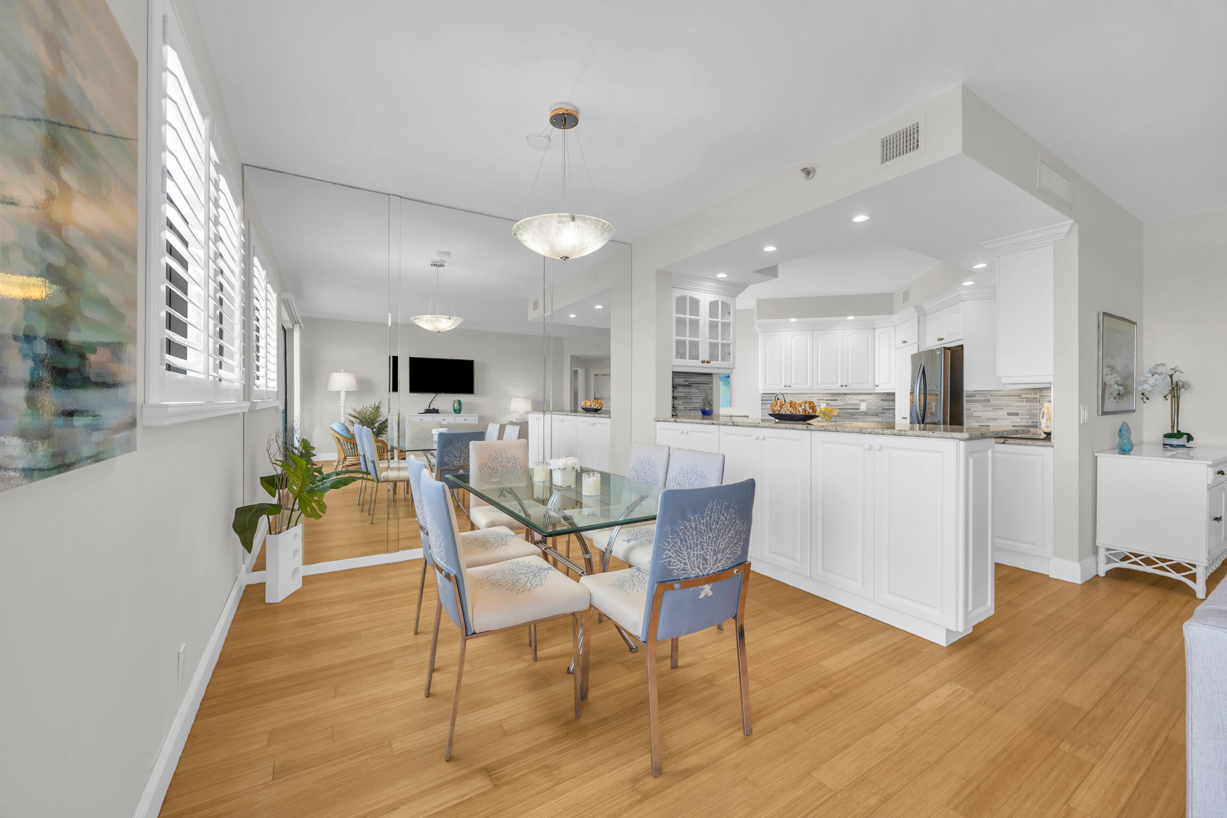 200 Waterway Road, Unit 206 Tequesta, FL 33469 - Photo 8 of 49 a view of a dining room with furniture and wooden floor