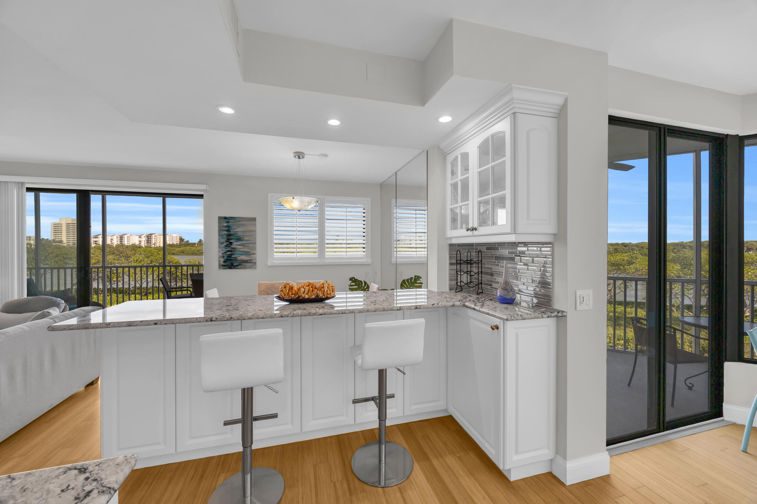 200 Waterway Road, Unit 206 Tequesta, FL 33469 - Photo 10 of 49 a kitchen with stainless steel appliances granite countertop a refrigerator and a sink