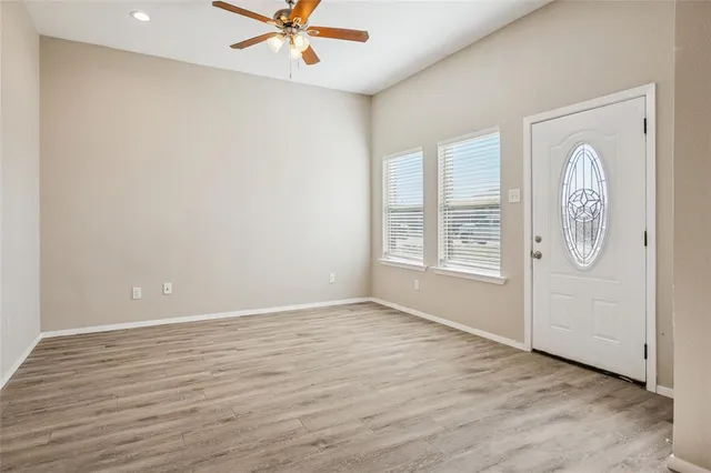 wooden floor in an empty room with a window
