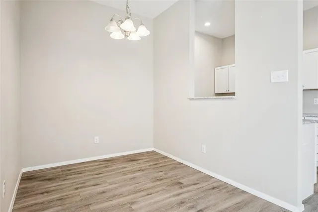 a view of a room with wooden floor and a ceiling fan
