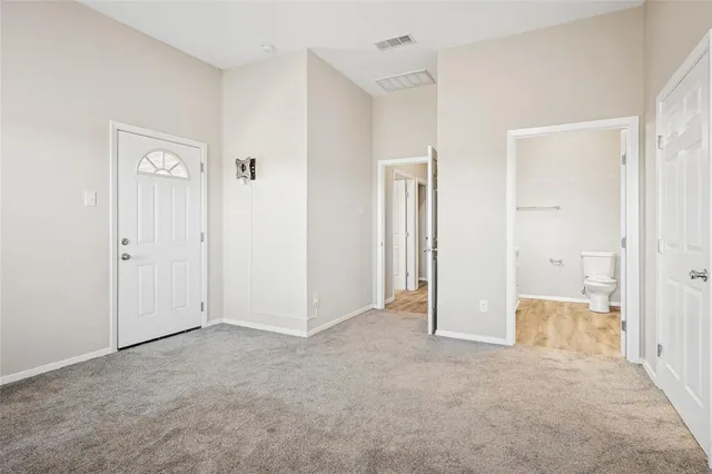 an empty room with windows and closet