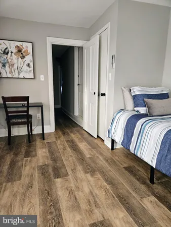 a bedroom with a bed and a chair