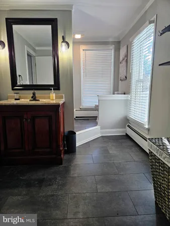 a bathroom with a sink a mirror and a bathtub