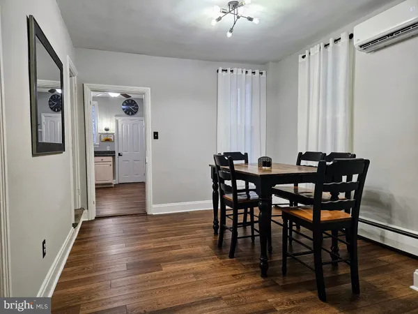 a view of a a dining room with furniture window and wooden floor