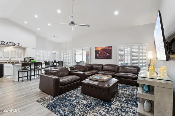 a living room with furniture wooden floor and a flat screen tv