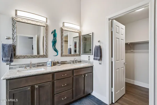 a bathroom with a double vanity sink and mirror