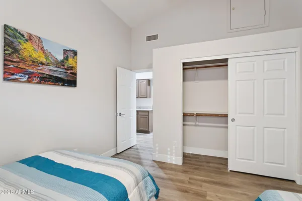 a bedroom with a bed and a painting on the wall