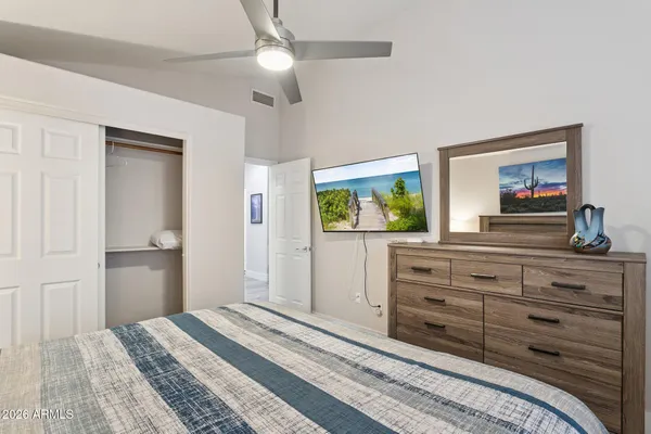 a bedroom with a bed and a dresser in it