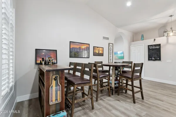 a view of a dining room with furniture and wooden floor