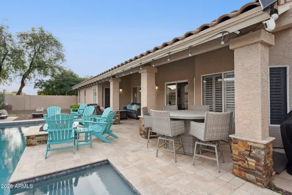 a view of a patio with table and chairs and potted plants