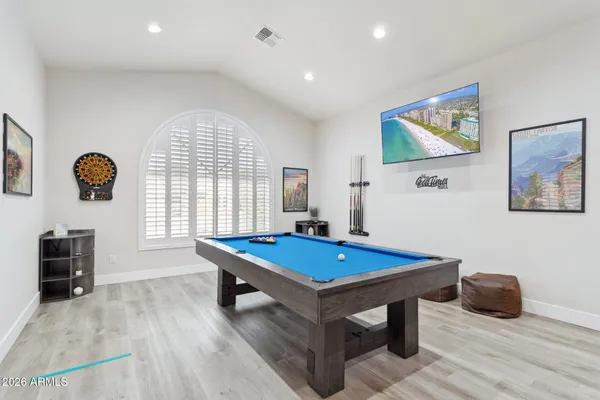 a room with pool table and windows