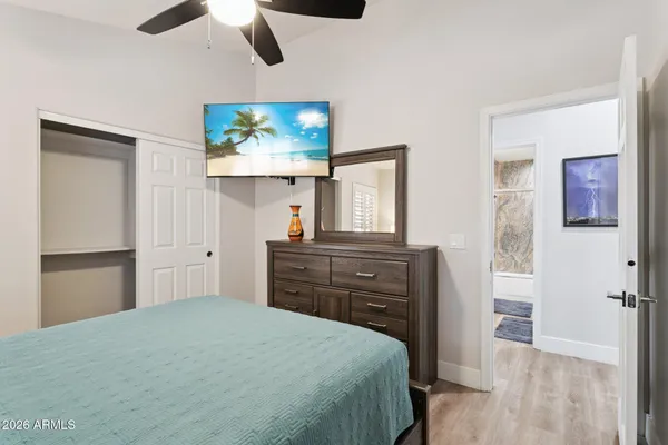 a bedroom with a bed and wooden floor