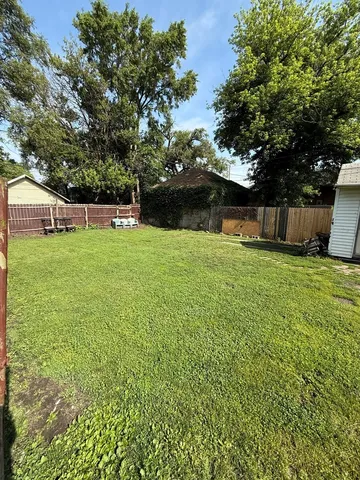 a view of a backyard with a small cabin