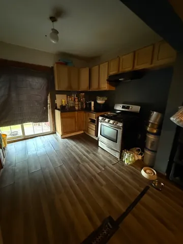 a kitchen with wooden floors and a stove
