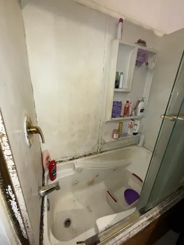 a bathroom with a bathtub and shower