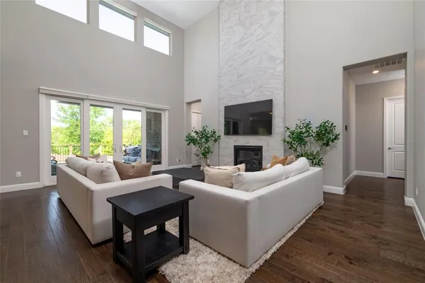 a living room with furniture a flat screen tv and a fireplace