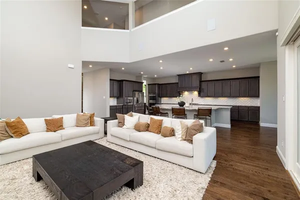 a living room with furniture and kitchen view