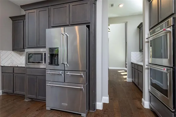 a kitchen with stainless steel appliances and wooden cabinets