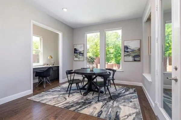 a view of a dining room with furniture and a window