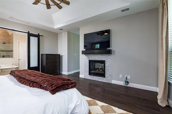 a bedroom with a bed and a fireplace