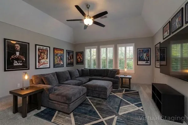 a living room with furniture and a ceiling fan