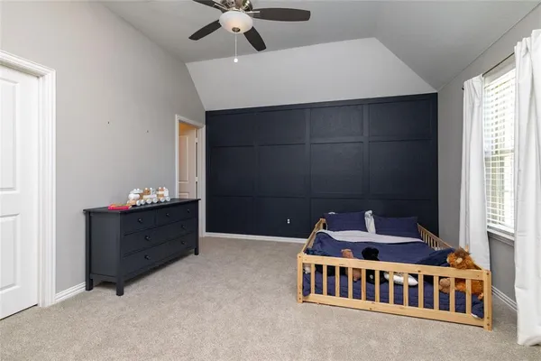 a bedroom with furniture and a window