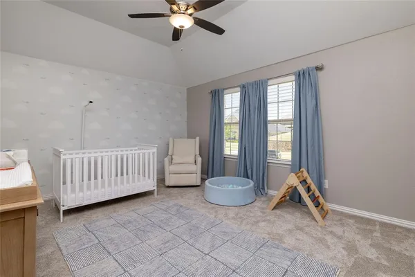 a view of a room with wooden floor and fan
