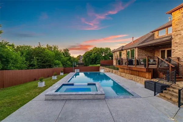 a view of house with swimming pool and sitting area