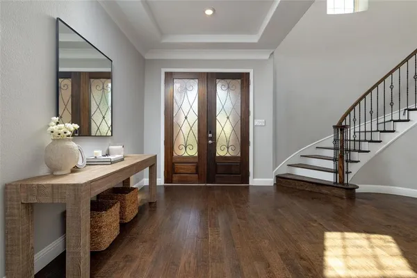 a view of a hallway with wooden floor and staircase