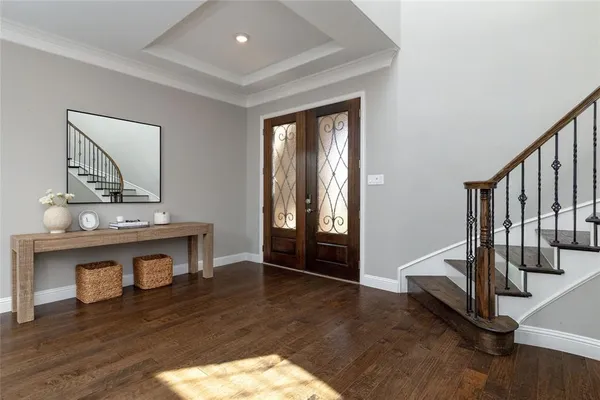 a view of an entryway with wooden floor