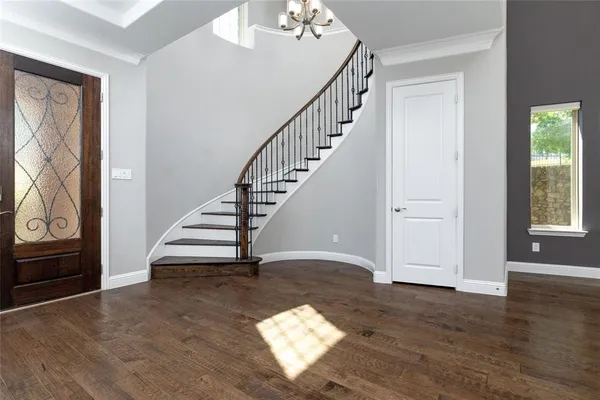 a view of entryway and hall with wooden floor