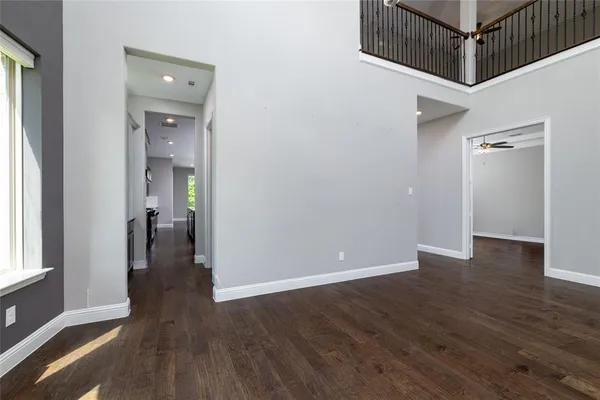 a view of a hallway with wooden floor and entryway