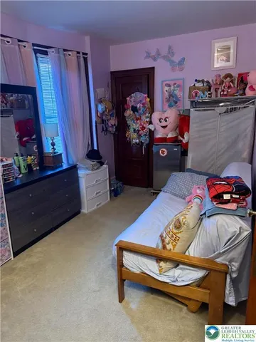 a bedroom with a bed and a mirror