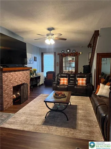 a living room with furniture fireplace and flat screen tv