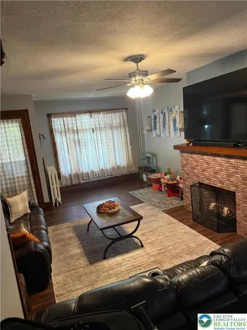 a living room with furniture fireplace and flat screen tv