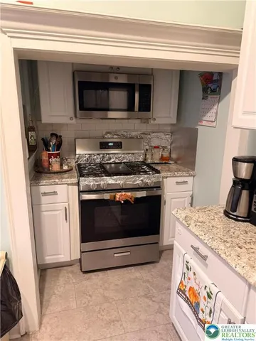 a living room with a couch and a potted plant